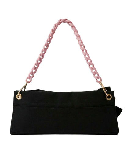 Back view of the Black Polka Edit pointe shoe bag — velcro back pocket, gold hardware eyelets and pink chain strap, by PointeBag By Ballerina