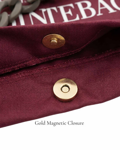 Close-up of gold magnetic closure on Burgundy Polka Edit ballet bag — 220g cotton canvas, by PointeBag By Ballerina