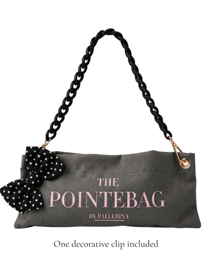 The PointeBag Dark Grey Polka Edit with decorative black polka dot bow clip — limited edition pointe shoe bag with black velvety chain and gold hardware, by PointeBag By Ballerina