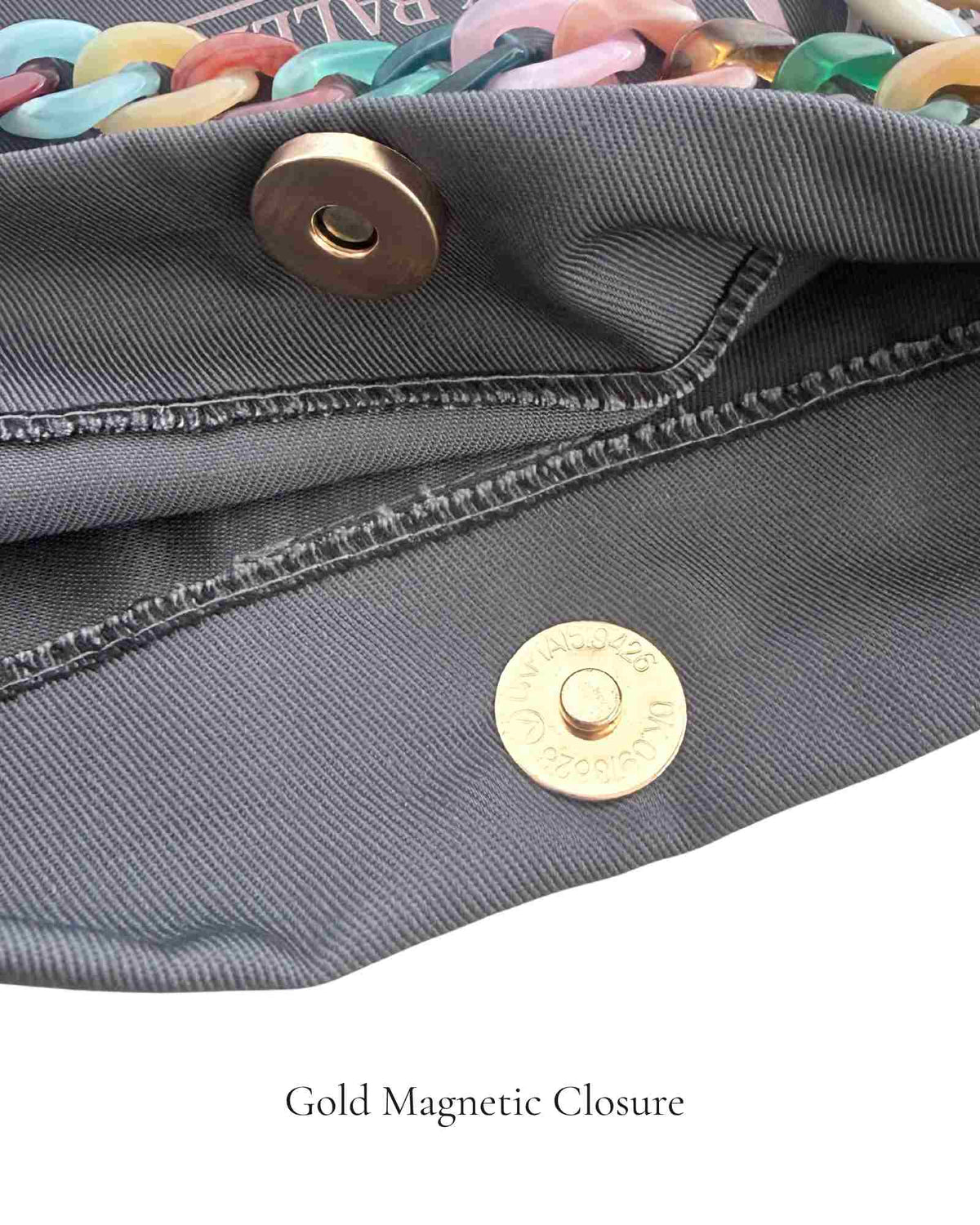 Dark grey PointeBag by Ballerina for pointe and ballet shoes showing the magnetic gold closure and colorful rainbow chain