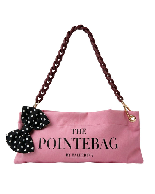 The PointeBag Classic Pink Polka Edit — blush pink pointe shoe bag with black polka dot bow and dark coffee chain strap by PointeBag By Ballerina