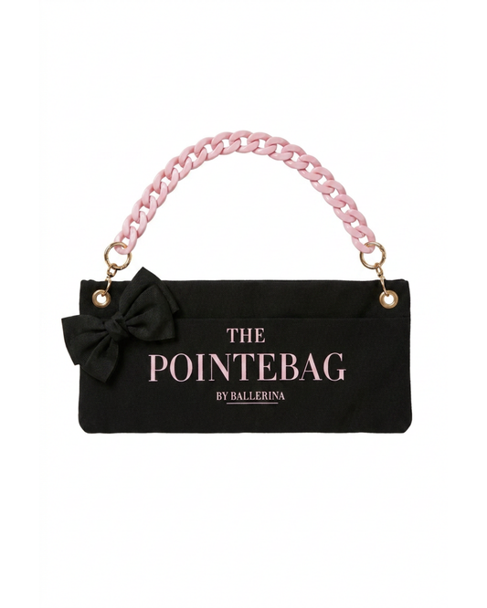 "The PointeBag By Ballerina in black — ballet bag with black bow and pink chain strap, gold hardware"