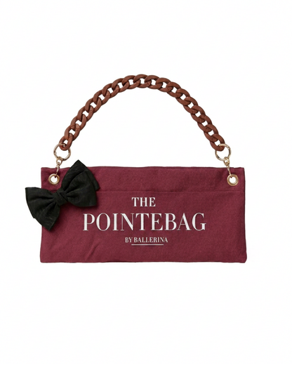"The PointeBag By Ballerina in burgundy with decorative clip attachment point — customizable ballet bag with dark chain strap and gold hardware"