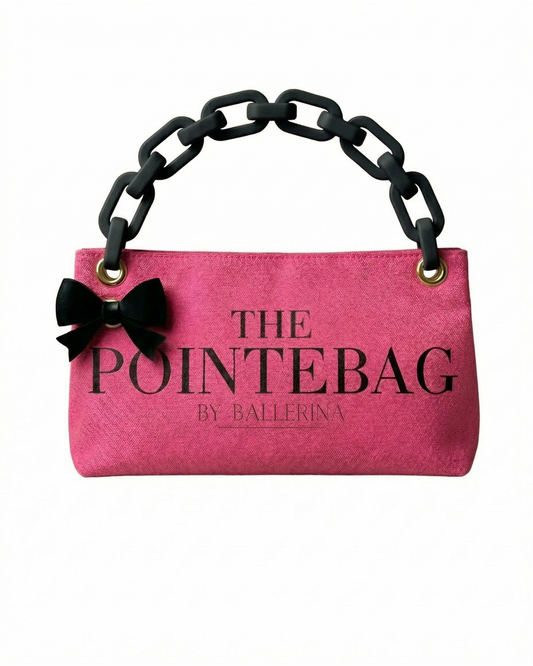  "Fuchsia Classic PointeBag made from vibrant pink Canva fabric featuring a stylish chain strap, a black bow accent, and the elegant 'The PointeBag by Ballerina' logo for a chic dance accessory