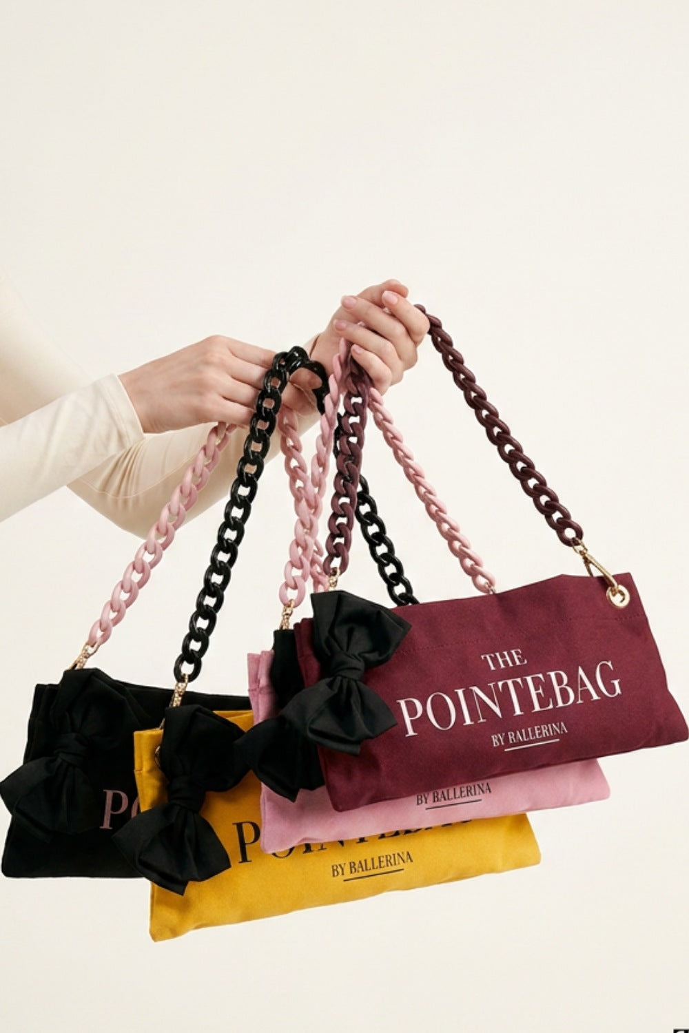 The PointeBag by Ballerina — scented pointe shoe bags in black, pink, burgundy and yellow with velvety chain straps