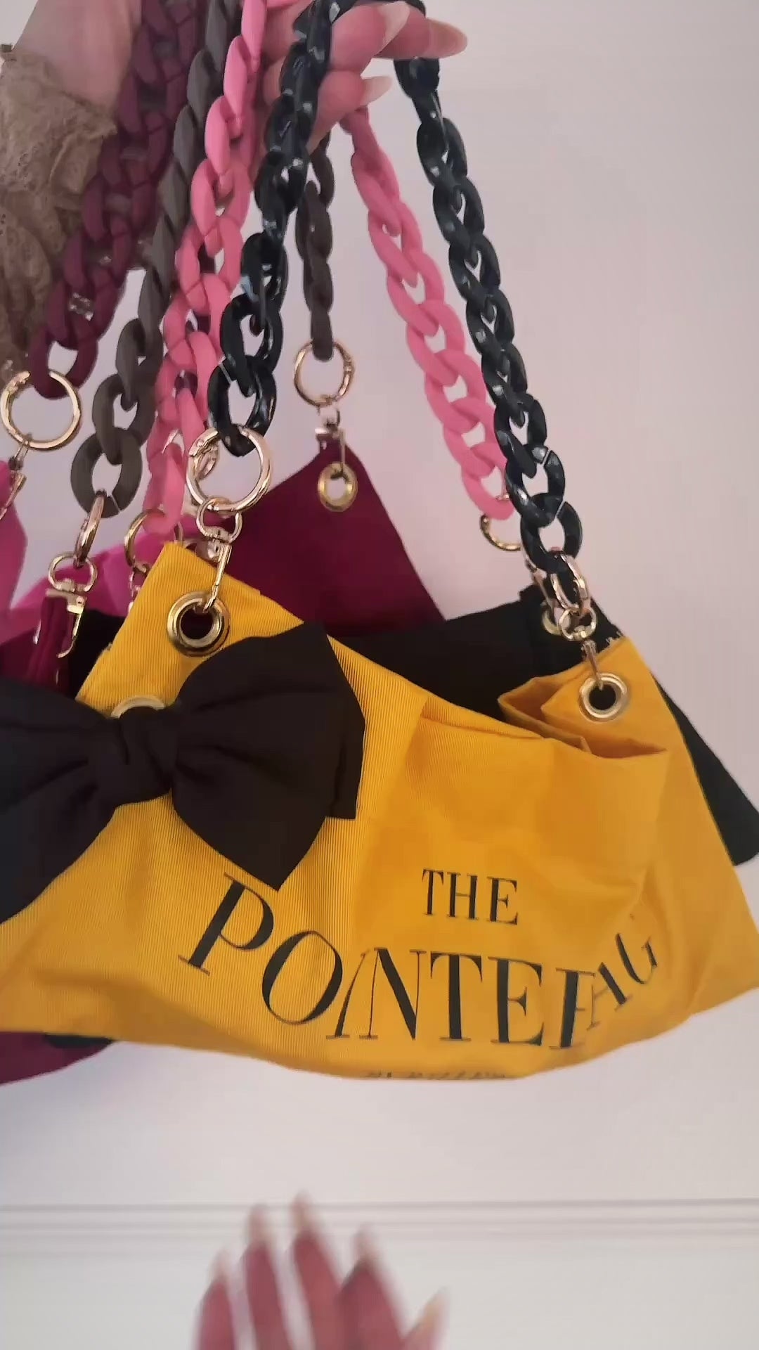 "PointeBag by Ballerina — close-up of premium cotton fabric, velvety touch, gold chains and swappable clips"